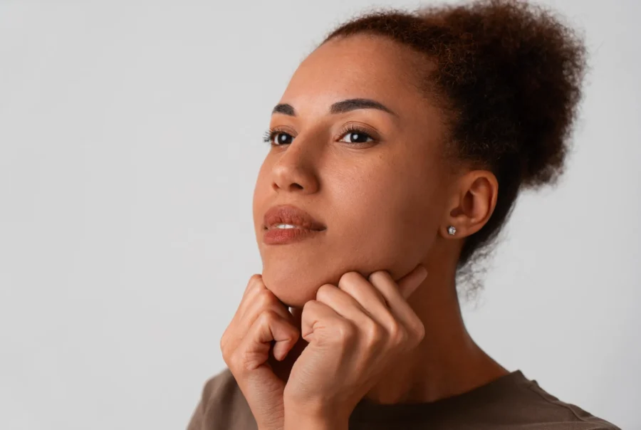 Portrait woman trying facial yoga massage stay young