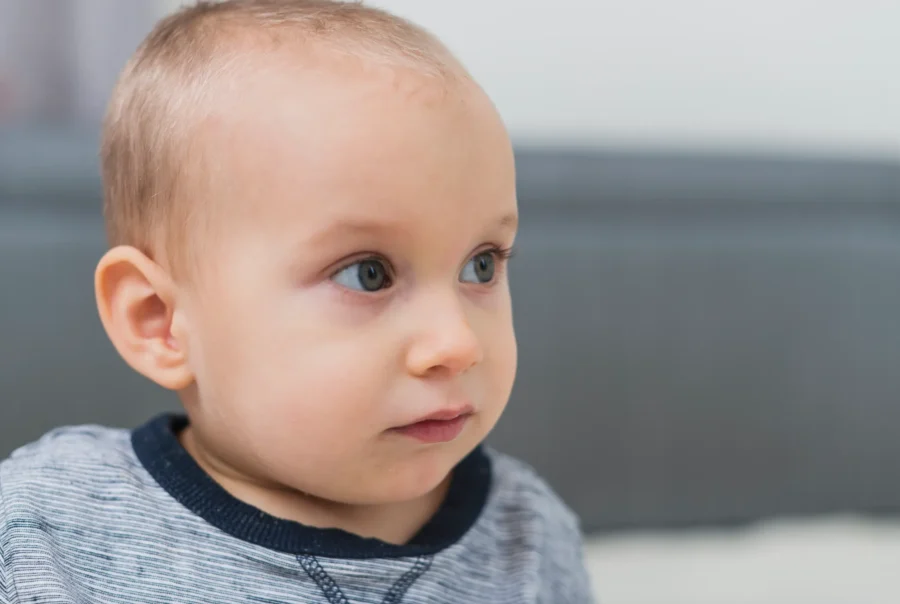 Infant Ear Molding Person with long hair, black shirt.