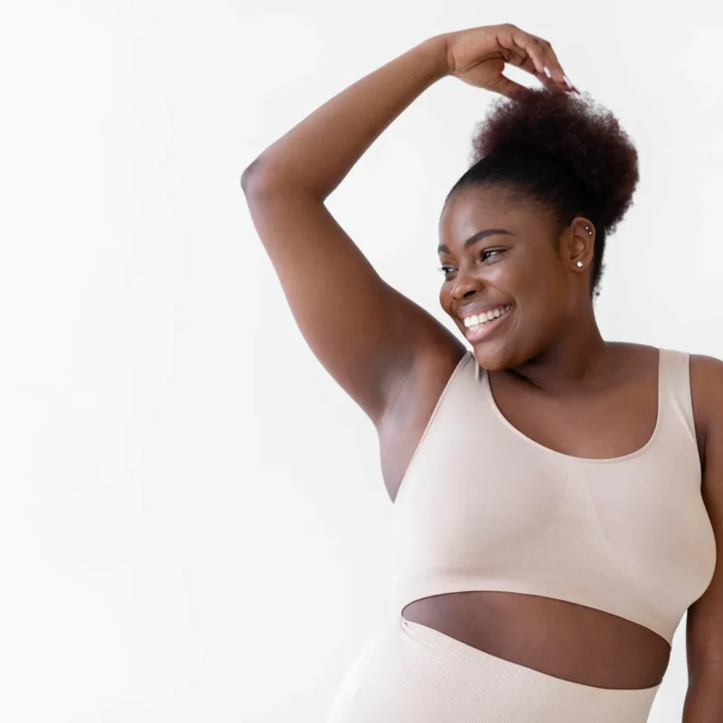 confident smiley woman posing while wearing body shaper with copy space
