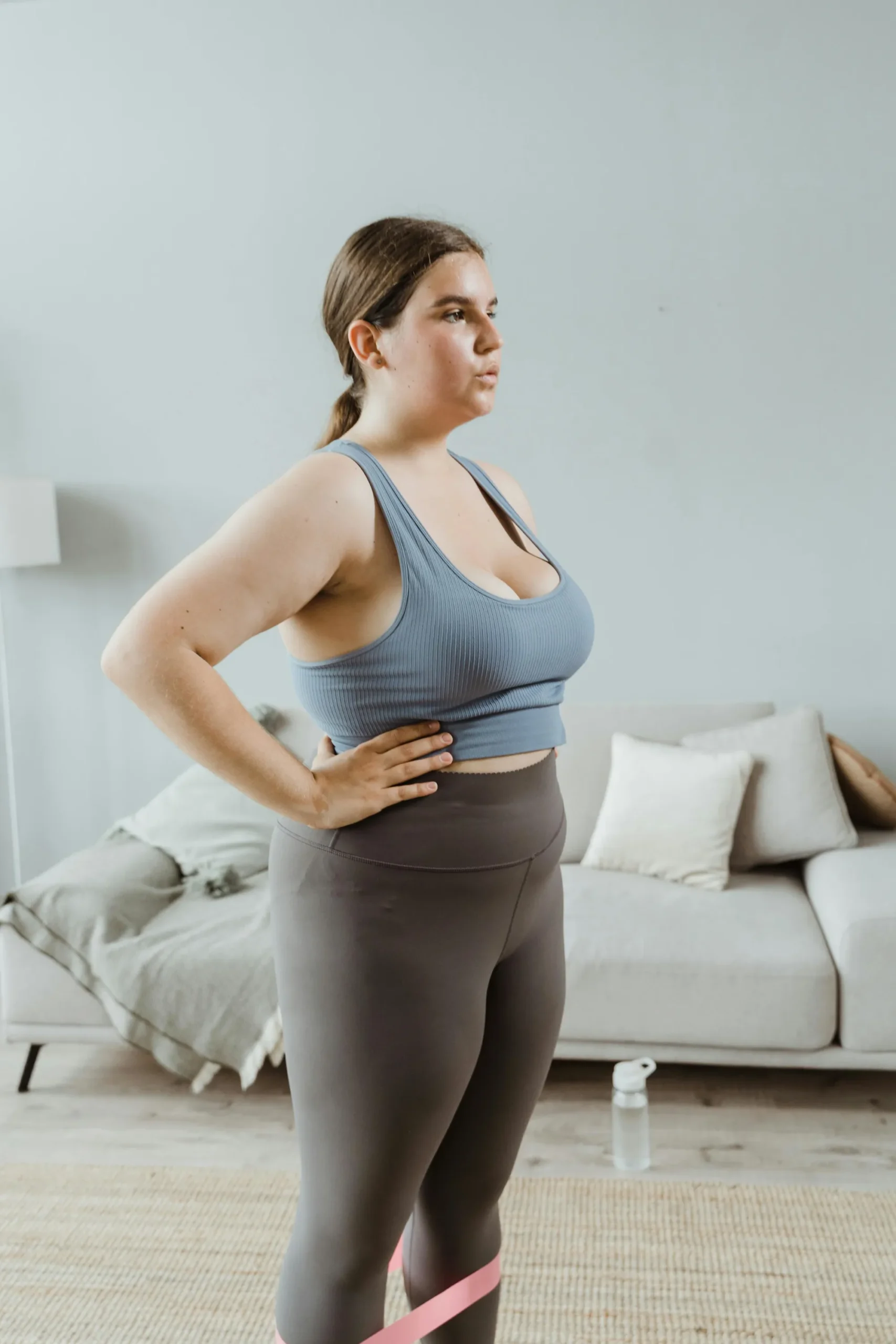 Mommy Makeover Woman exercising in a living room.