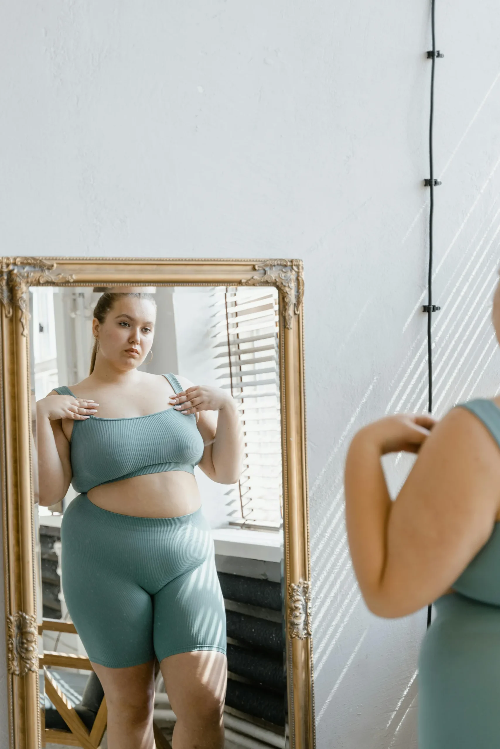 Woman admiring herself in mirror.
