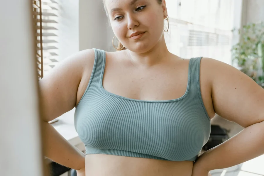 Woman in green activewear posing confidently.