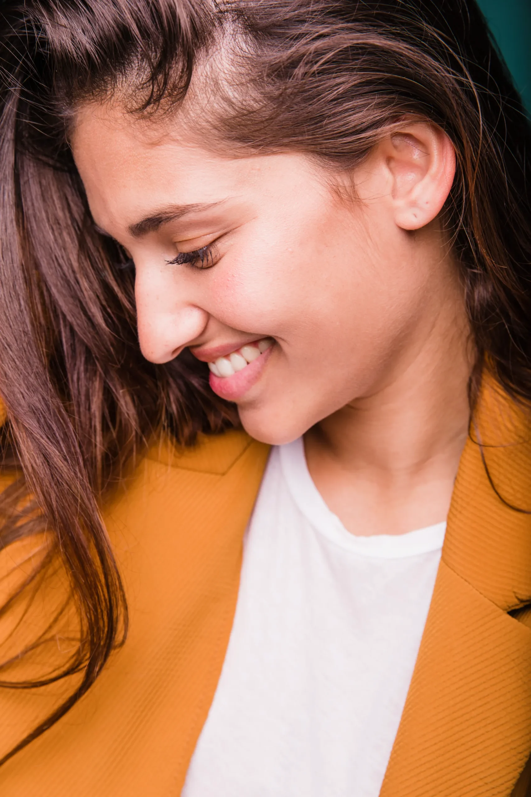 smiling brunette girl posing with coat scaled