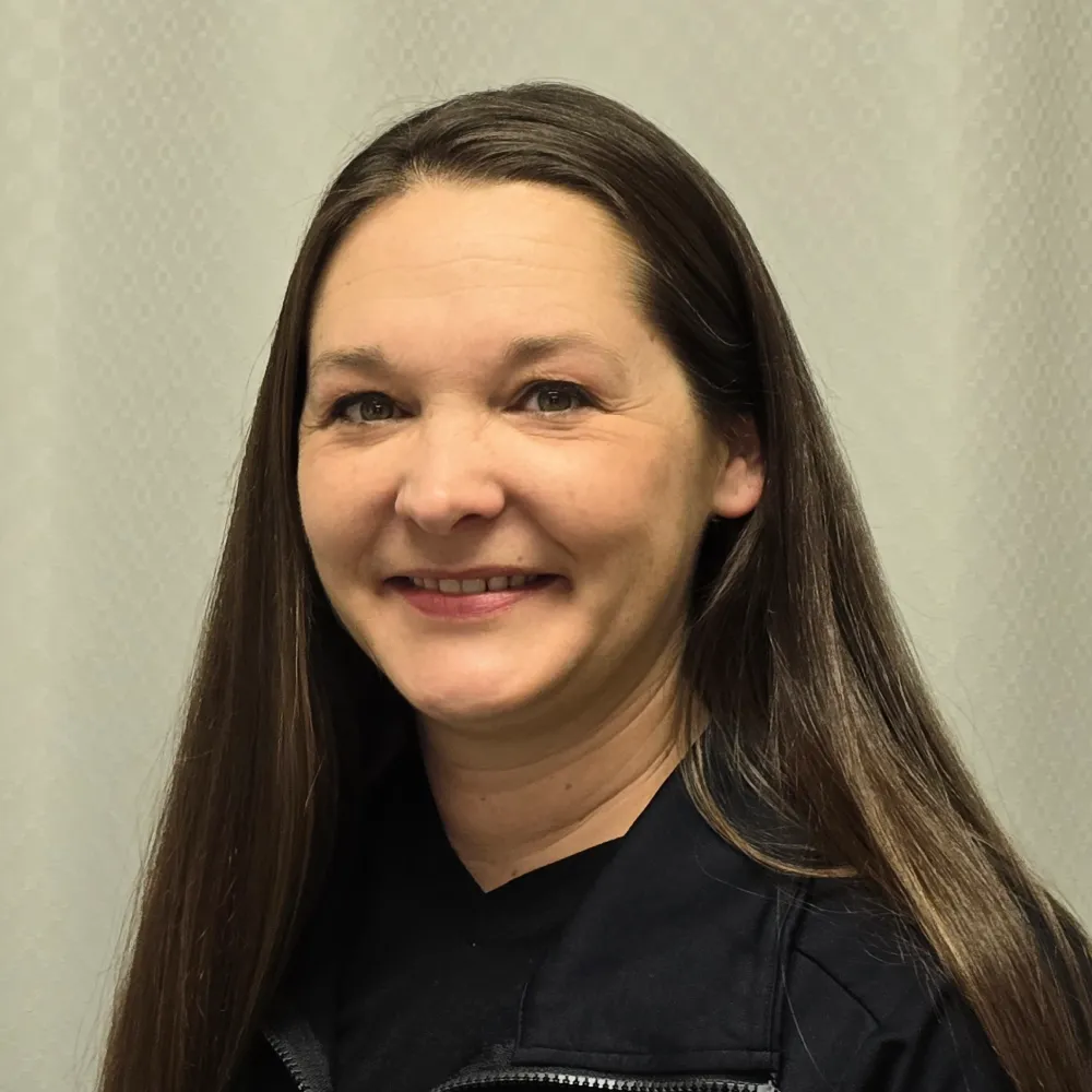 Person with long hair, black shirt.